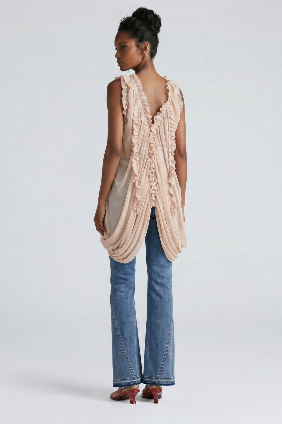 Isis Cascade Ruffle Draped Tunic Top styled in the studio